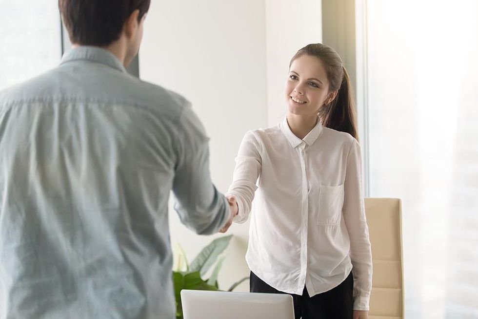 Woman shakes ⁤hands​ with colleague after an informational interview